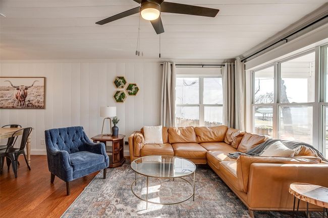 Living room featuring wood finished floors, plenty of natural light, and a ceiling fan | Image 8