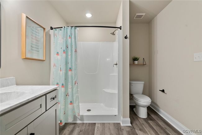 Bathroom with hardwood / wood-style flooring, a shower with curtain, toilet, and vanity | Image 27