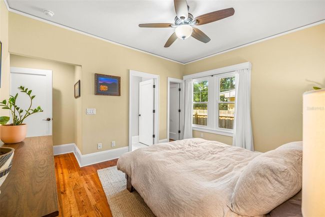 A walk-in closet next to the window and entry to the primary bathroom beside it. | Image 19