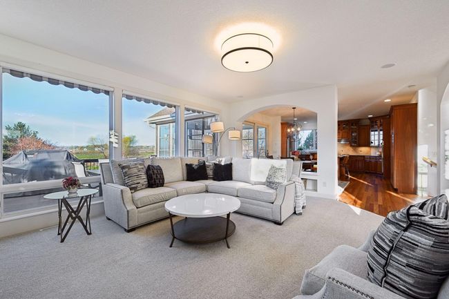 View from family room looking into informal dining room and kitchen. | Image 16