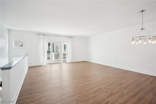Unfurnished room with a chandelier, baseboards, and wood finished floors | Image 10