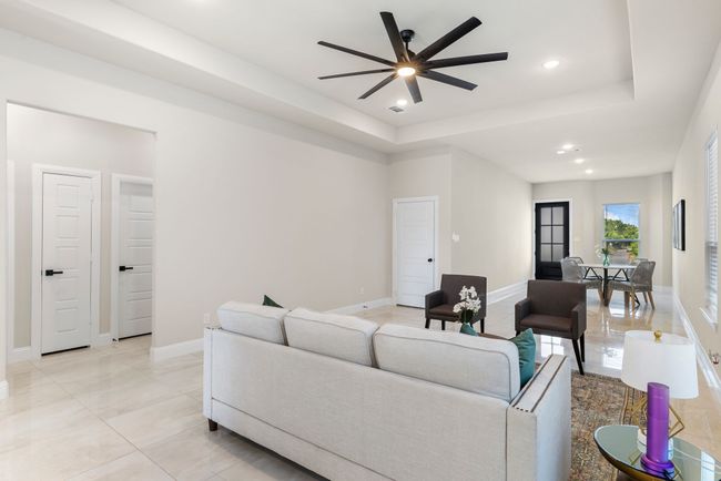 Living room featuring recessed lighting, baseboards, a tray ceiling, and ceiling fan | Image 15