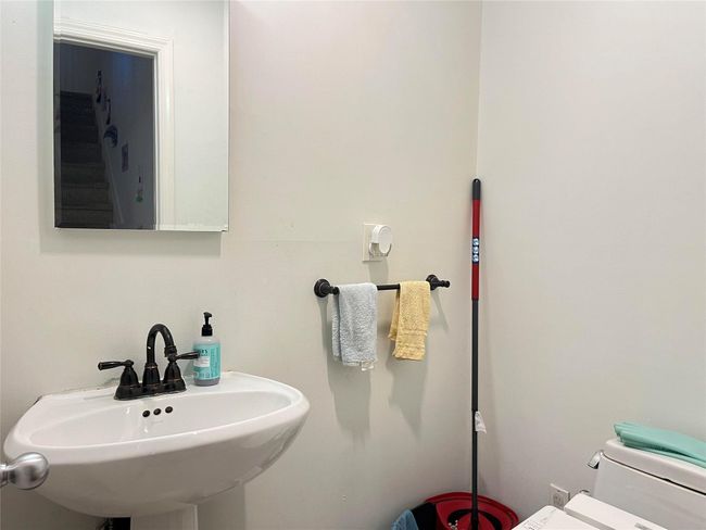 Bathroom featuring toilet and a sink | Image 14