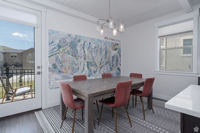 Dining room featuring wood finished floors, baseboards, and beamed ceiling | Image 16
