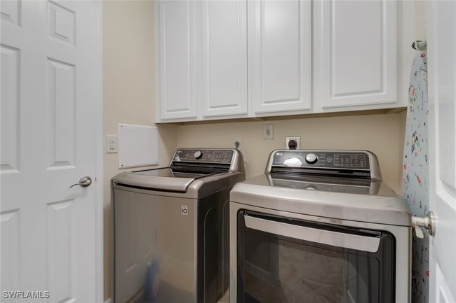 Laundry room with cabinet space and washer and clothes dryer | Image 20