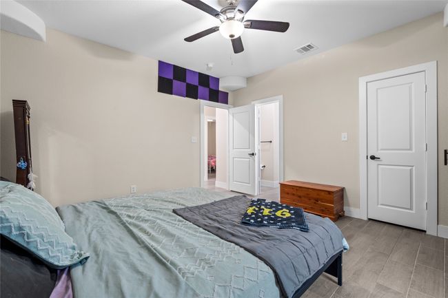 Bedroom featuring a ceiling fan and wood finished floors | Image 31