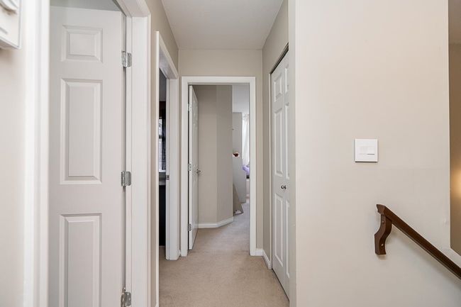 Hall with light carpet and baseboards | Image 27