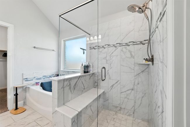 Bathroom with a garden tub, a marble finish shower, lofted ceiling, and marble finish floors | Image 22