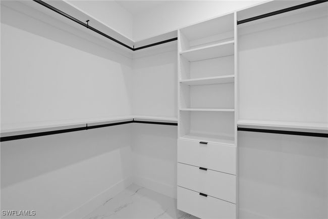 Spacious closet with light marble finish floors | Image 26
