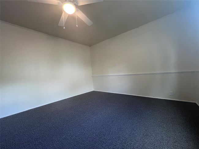 Unfurnished room with a ceiling fan and carpet | Image 13