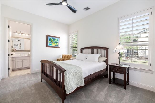 Bedroom featuring light carpet, baseboards, ensuite bath, and a sink | Image 25