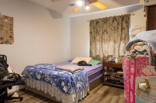 Bedroom featuring wood finished floors and a ceiling fan | Image 11