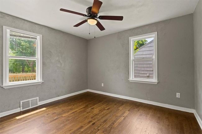 Empty room with hardwood / wood-style floors and a ceiling fan | Image 15