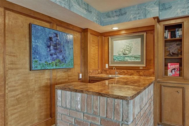 Ideal for hosting, the wet bar adds convenience and style to your entertaining space. | Image 29