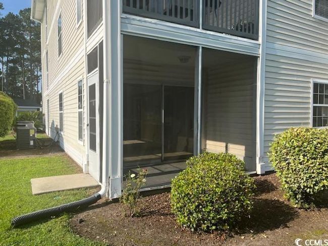 View of side of home with a cooling unit and a sunroom | Image 10