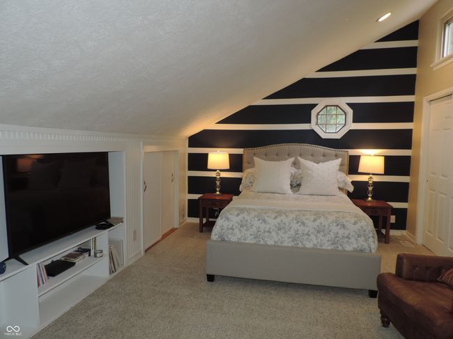 bedroom featuring lofted ceiling | Image 15