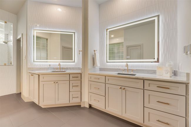So many details in this bathroom including heated floors and backlit mirrors along with additional lighting in tub nook. | Image 12