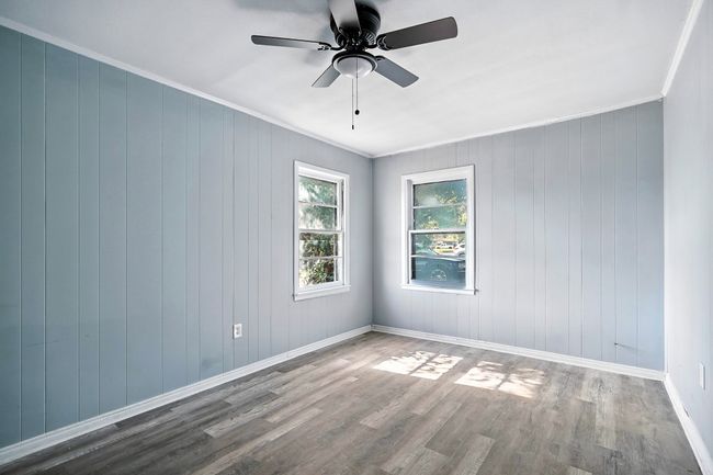 Unfurnished room with wood finished floors, ornamental molding, and a ceiling fan | Image 16