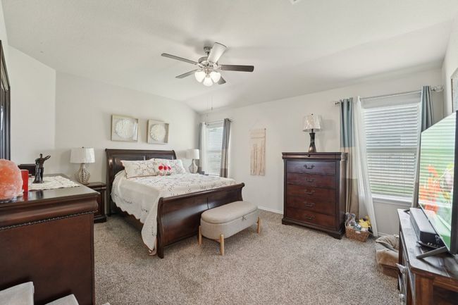 Bedroom with light carpet and a ceiling fan | Image 23