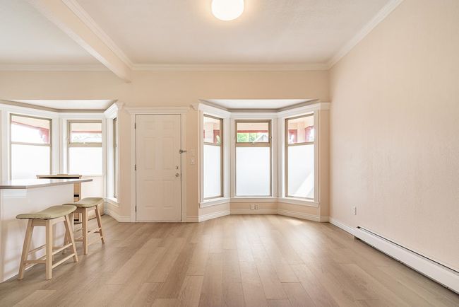 Foyer entrance featuring a baseboard heating unit, light wood-style flooring, and ornamental molding | Image 8