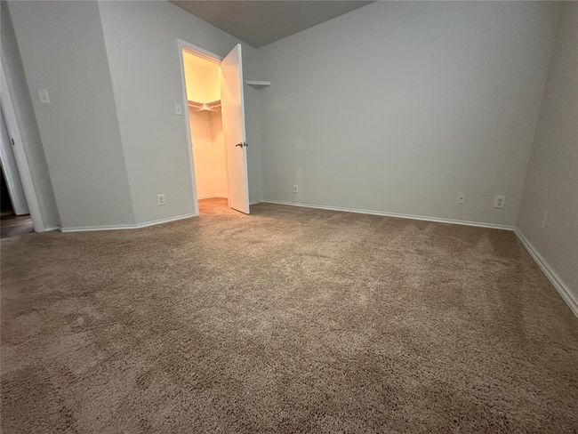Unfurnished bedroom with carpet flooring and a walk in closet | Image 28
