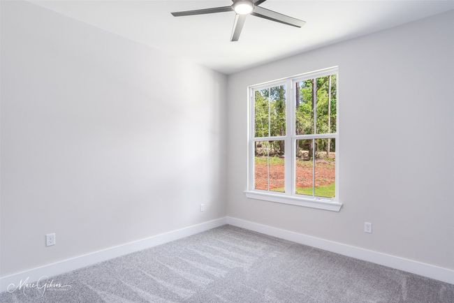 Carpeted spare room featuring a ceiling fan and baseboards | Image 16