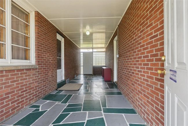 Breezeway between garage and home with access to front and back yards | Image 5