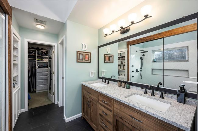 Bathroom with tiled shower, vanity, and tile patterned flooring | Image 19