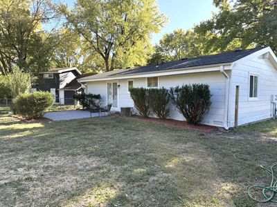 Ranch-style house featuring a front yard and cooling unit | Image 2