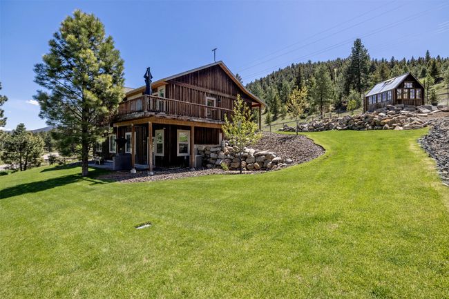 Back of property featuring a lawn and a wooden deck | Image 5
