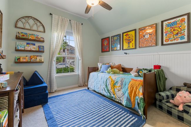 Carpeted bedroom with vaulted ceiling and a ceiling fan | Image 21