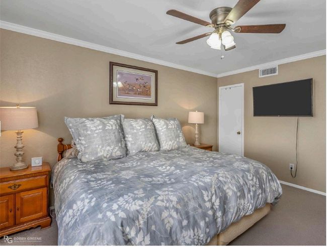 Bedroom with baseboards, visible vents, a ceiling fan, crown molding, and carpet floors | Image 16