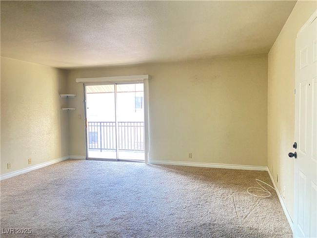 Carpeted empty room with a textured ceiling and baseboards | Image 7