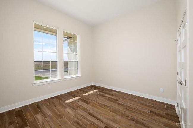 Spare room with dark wood-style flooring and baseboards | Image 24