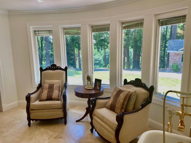 Sitting area in master bath, turn chairs around and enjoy your property views out the Pella windows! | Image 32