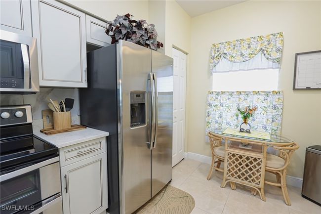 Kitchen featuring appliances with stainless steel finishes and light tile flooring | Image 10