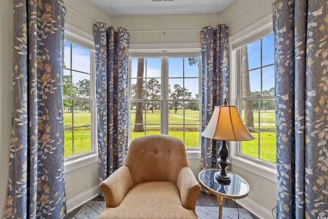 Sitting room featuring baseboards and view of golf course | Image 10