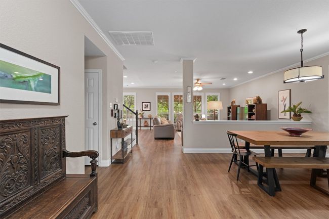 View from front foor, Office is to your right. Dining space featuring ornamental molding, light wood-style floors, baseboards, recessed lighting, and ceiling fan | Image 4