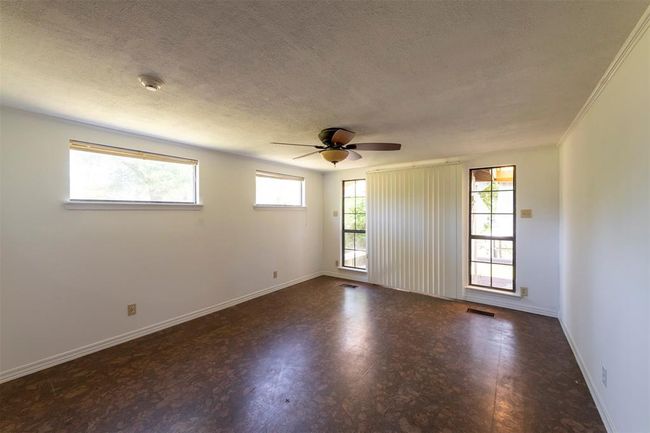 Primary bedroom features a sliding glass door that opens onto the deck. | Image 15