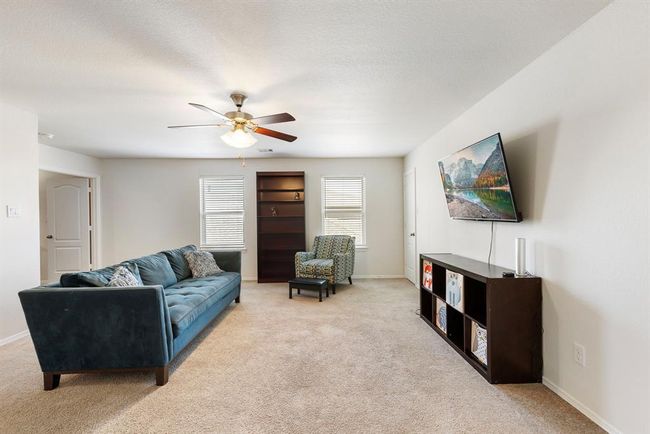 As you come up the stairs you are greeted with a spacious game room with lots of natural light & a storage closet. | Image 30