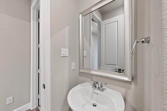 Bathroom featuring a textured wall and a sink | Image 13