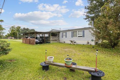 Exterior space featuring a front yard and a carport | Image 3