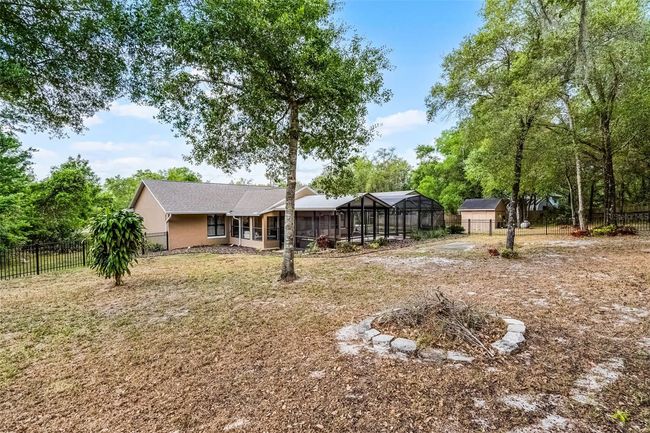 Fenced in backyard complete with a fire pit and RV parking pad | Image 29