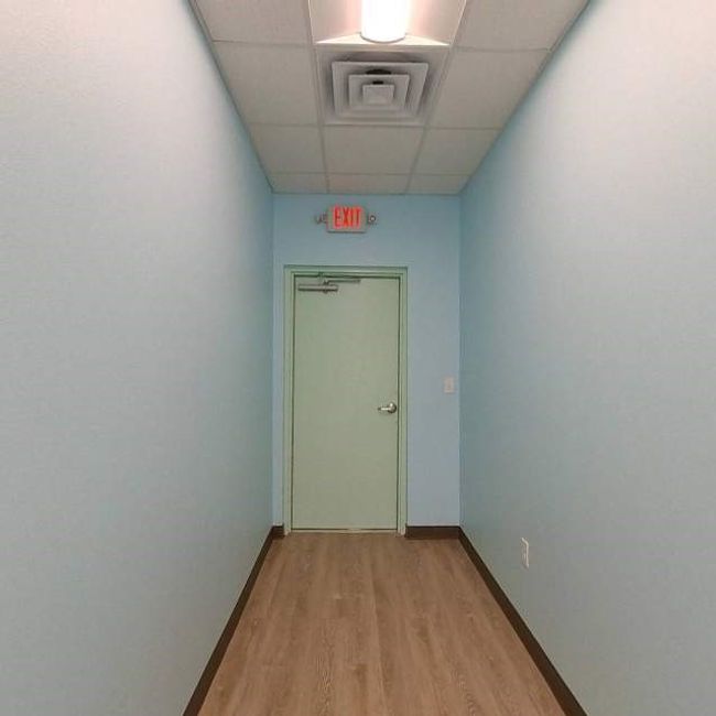 Hallway with a drop ceiling, light wood finished floors, and baseboards | Image 13