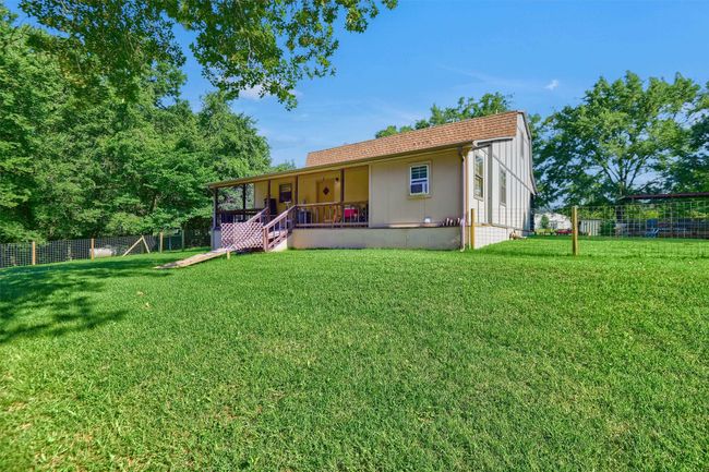 Back of property with a lawn, a porch, and fence | Image 28