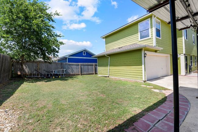 Fenced yard featuring an attached garage and driveway | Image 39