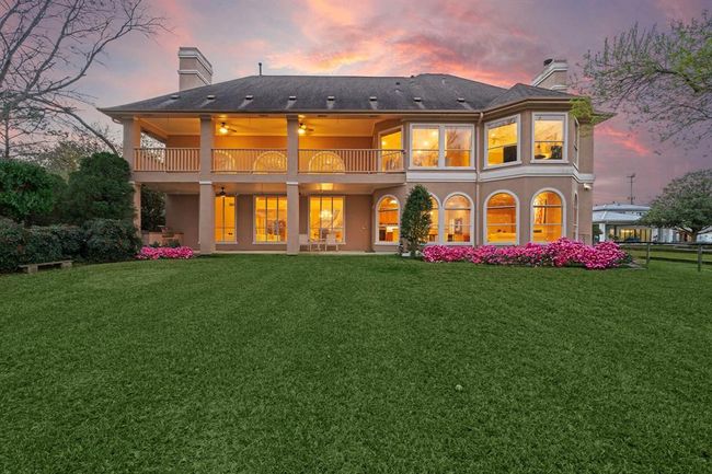 Spanning 2.89 acres, this magnificent home is complemented by expansive lawns and abundant windows that enhance its stunning beauty. | Image 6