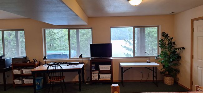 Basement office space featuring baseboards, visible vents, and a wealth of natural light | Image 41