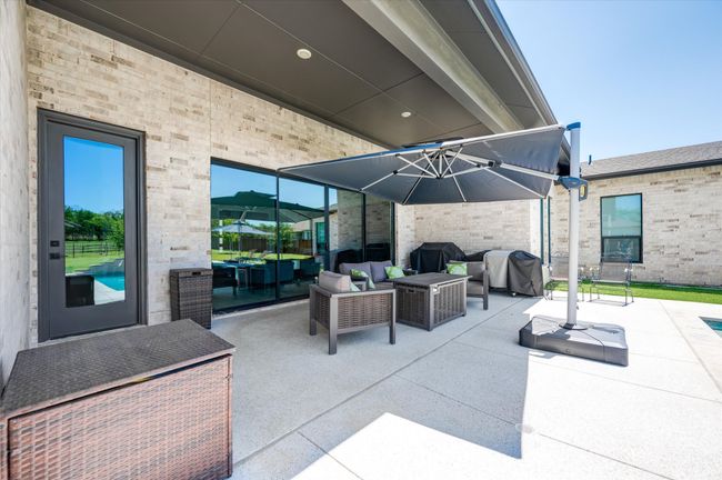 View of patio featuring grilling area and outdoor lounge area | Image 29