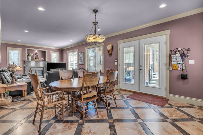 Dining area featuring inlaid floor details, recessed lighting, french doors, ornamental molding, and baseboards | Image 15
